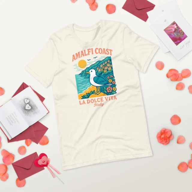 ☀️ Amalfi Coast Vibes on a Tee – La Dolce Vita Never Looked So GoodCapture that coastal grandma meets bird nerd vibe in the best way with this La Dolce Vita t-shirt! Featuring a sunlit Amalfi Coast view and a bold seagull, it’s the perfect summer piece for Italy lovers, birdwatchers, and anyone craving a sip of Positano life. Soft, flattering, and made for adventures (or aperitivo), this Italy souvenir shirt is your new go-to.#ItalyGirlsTrip #BirdLoverStyle #LaDolceVitaShirt #AmalfiCoastTee #BeachVibesOnly #FishermanAesthetic